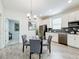 Bright kitchen and dining area featuring stainless steel appliances, modern cabinets, and a stylish glass table at 8886 Fallen Oak Dr, Davenport, FL 33896