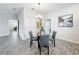 Open dining area with modern lighting, glass table, and easy access to other rooms, ideal for gatherings at 8886 Fallen Oak Dr, Davenport, FL 33896