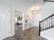 Elegant foyer with wood-look tile flooring, a staircase with iron railings, and a view into the living area at 8886 Fallen Oak Dr, Davenport, FL 33896