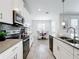 Modern kitchen featuring stainless steel appliances, white cabinets, sleek countertops, and eat in dining area at 8886 Fallen Oak Dr, Davenport, FL 33896