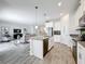 Modern open concept kitchen featuring white cabinetry, stainless appliances, and seamless integration to living space at 8886 Fallen Oak Dr, Davenport, FL 33896