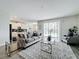 Open-concept living room boasts a plush gray sofa, modern decor, and sliding glass doors to outdoor space at 8886 Fallen Oak Dr, Davenport, FL 33896