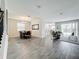 Open-concept living and dining area with wood-look tile flooring and access to the outdoor patio at 8886 Fallen Oak Dr, Davenport, FL 33896
