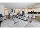 Spacious living room featuring sleek furniture, modern finishes, and an inviting open layout to kitchen at 8886 Fallen Oak Dr, Davenport, FL 33896