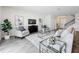 Modern living room offers cozy seating, a stylish entertainment center, and an open floor plan at 8886 Fallen Oak Dr, Davenport, FL 33896