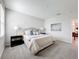 Calm main bedroom featuring soft bedding, carpet flooring, matching lamps and decorative pillows at 8886 Fallen Oak Dr, Davenport, FL 33896
