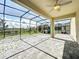 Spacious screened patio with playset and open view at 8886 Fallen Oak Dr, Davenport, FL 33896