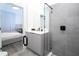 Stylish bathroom with gray tile, glass shower, and vanity with sink at 9029 Ibiza Ln # 1, Kissimmee, FL 34747