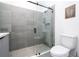 Modern bathroom with a large walk-in shower and grey tile at 9029 Ibiza Ln # 1, Kissimmee, FL 34747