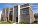 Modern townhome with gray exterior, stone accents, and walkway at 9029 Ibiza Ln # 1, Kissimmee, FL 34747