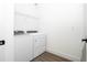 Bright laundry room with washer, dryer, and shelving at 9029 Ibiza Ln # 1, Kissimmee, FL 34747