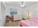 Bedroom with a pink bedspread, white dresser, and built-in shelving at 905 Suwannee Dr, Apopka, FL 32703