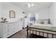 Bedroom with a metal bed frame, white dresser, and a window at 905 Suwannee Dr, Apopka, FL 32703