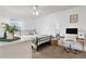 Bedroom with a metal bed frame, white dresser, and workspace at 905 Suwannee Dr, Apopka, FL 32703