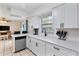 Modern kitchen with white cabinets, quartz countertops and stainless steel appliances at 905 Suwannee Dr, Apopka, FL 32703