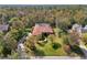 Aerial view of a luxurious home with a tile roof, lush landscaping, and a large backyard at 10 Broadwater Dr, Ormond Beach, FL 32174