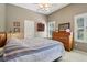 Spacious bedroom with wood dresser and striped bedding at 10 Broadwater Dr, Ormond Beach, FL 32174