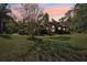 House exterior at dusk, showcasing a landscaped yard and tile roof at 10 Broadwater Dr, Ormond Beach, FL 32174