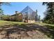 House exterior showcasing a large screened pool enclosure and lush landscaping at 10 Broadwater Dr, Ormond Beach, FL 32174