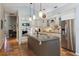 Spacious kitchen with island, stainless steel appliances, and terracotta tile floors at 10 Broadwater Dr, Ormond Beach, FL 32174