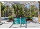 Screened pool with lush landscaping and fountain feature at 10 Broadwater Dr, Ormond Beach, FL 32174