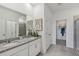 Double vanity bathroom with granite countertop and walk-in shower at 10140 Huntingnet Way, Leesburg, FL 34748