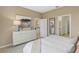 Bedroom with dresser and view into the kitchen at 10140 Huntingnet Way, Leesburg, FL 34748