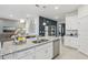 Kitchen island with granite countertop and double sink at 10140 Huntingnet Way, Leesburg, FL 34748