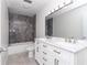 Updated bathroom featuring a marble vanity and gray shower at 11431 Nw 100Th St, Ocala, FL 34482