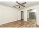 Bright bedroom with mirrored closet doors and ceiling fan at 11431 Nw 100Th St, Ocala, FL 34482