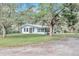 White single story home with large trees and a spacious yard at 11431 Nw 100Th St, Ocala, FL 34482