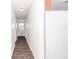 Long hallway with light walls and wood-look floors at 11431 Nw 100Th St, Ocala, FL 34482