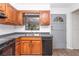 Cozy kitchen featuring wood cabinets, a double sink and modern appliances at 11431 Nw 100Th St, Ocala, FL 34482