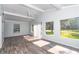 Sunlit living room with sliding doors and wood-look floors at 11431 Nw 100Th St, Ocala, FL 34482