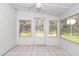 Sunroom featuring tiled floors and multiple windows at 11431 Nw 100Th St, Ocala, FL 34482