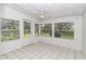 Spacious sunroom with tiled flooring and garden views at 11431 Nw 100Th St, Ocala, FL 34482