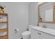 Simple bathroom with white vanity, toilet and wood shelf at 1255 Blackwater Pond Dr, Orlando, FL 32828