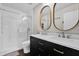 Modern bathroom with a double vanity, a large shower, and stylish mirrors at 1255 Blackwater Pond Dr, Orlando, FL 32828