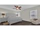 Spacious bedroom with king-size bed, dark hardwood floors, and ceiling fan at 1255 Blackwater Pond Dr, Orlando, FL 32828