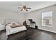 Cozy bedroom featuring a comfortable bed, a workspace, and dark flooring at 1255 Blackwater Pond Dr, Orlando, FL 32828