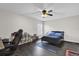 Modern bedroom with dark floors, a gaming chair, and a queen-size bed at 1255 Blackwater Pond Dr, Orlando, FL 32828