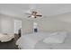 Main bedroom with king-size bed, en-suite bathroom access, and ceiling fan at 1255 Blackwater Pond Dr, Orlando, FL 32828