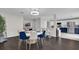 Bright dining room features a round table with blue and beige chairs, and dark hardwood floors at 1255 Blackwater Pond Dr, Orlando, FL 32828