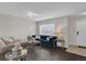 Living room with dark hardwood floors, a navy blue couch, and a white door at 1255 Blackwater Pond Dr, Orlando, FL 32828