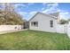 House backyard with grassy lawn, patio, and screened porch at 14087 Bradbury Rd, Orlando, FL 32828