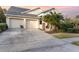 Two-car garage, landscaped yard, and a welcoming porch at 14087 Bradbury Rd, Orlando, FL 32828