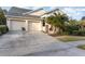 Two-car garage,palm trees, and neatly landscaped yard at 14087 Bradbury Rd, Orlando, FL 32828