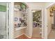 A well-lit hallway with built-in shelving and access to bedrooms at 14087 Bradbury Rd, Orlando, FL 32828