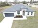 One-story house with gray roof, white walls, and a dark gray garage door at 14511 Sw 29Th Ter, Ocala, FL 34473