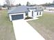 One-story house with gray roof, white walls, and a dark gray garage door at 14511 Sw 29Th Ter, Ocala, FL 34473